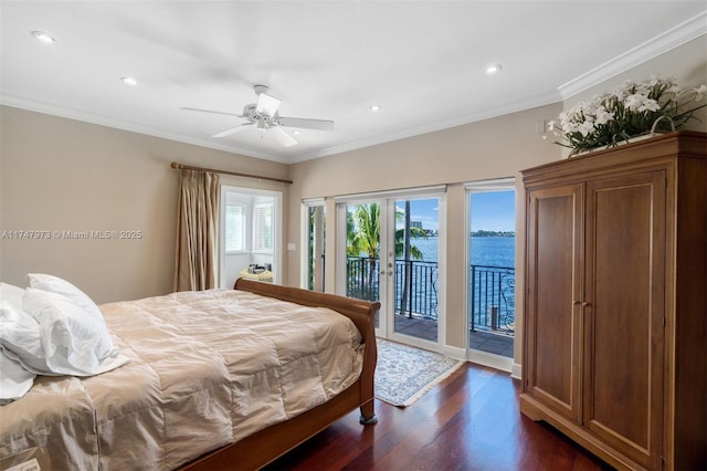 bedroom featuring a water view, access to exterior, crown molding, and dark wood-style flooring