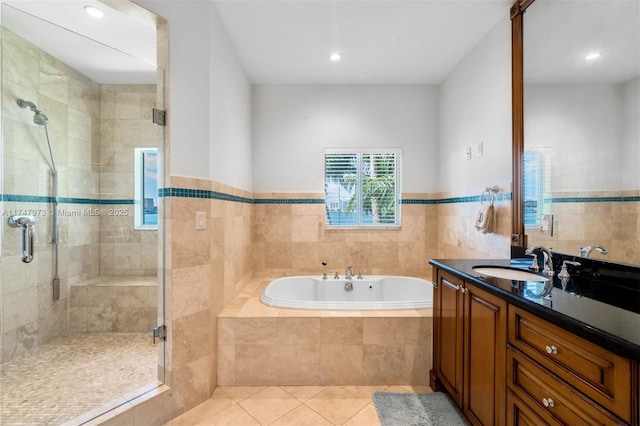 bathroom with tile patterned flooring, a garden tub, vanity, and a shower stall