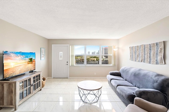 tiled living area with baseboards, a view of city, and a textured ceiling