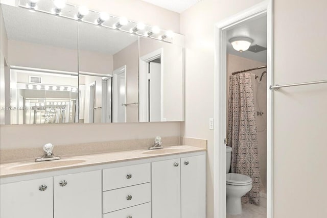 full bath featuring double vanity, visible vents, toilet, and a sink