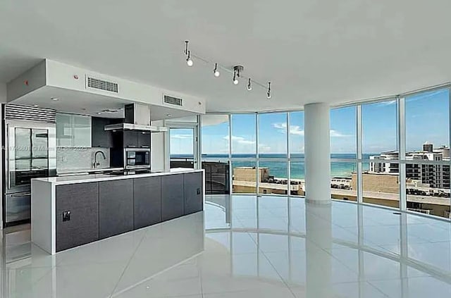 kitchen with light countertops, visible vents, a water view, and modern cabinets