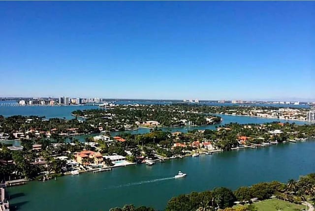 birds eye view of property featuring a view of city and a water view