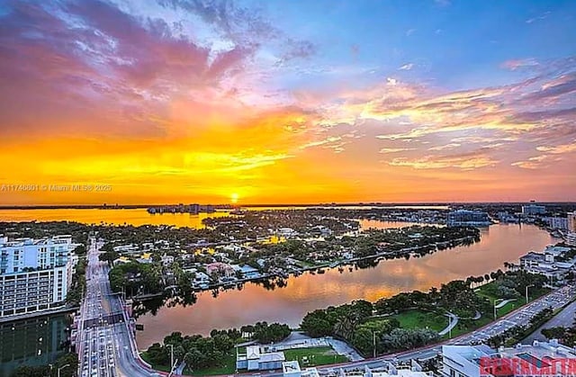 aerial view at dusk with a water view