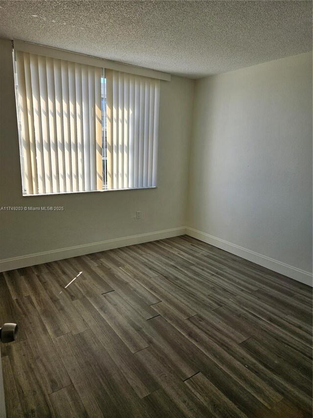 9320 Fontainebleau Blvd Unit 401, Miami, FL 33172 - empty room with a textured ceiling, baseboards, and dark wood-style flooring