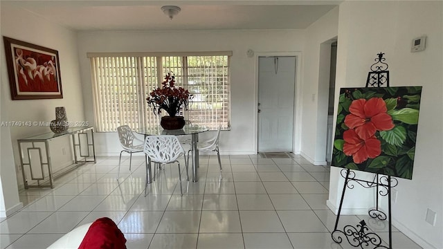 dining room with light tile patterned floors and baseboards