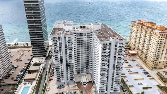 birds eye view of property featuring a water view and a view of city