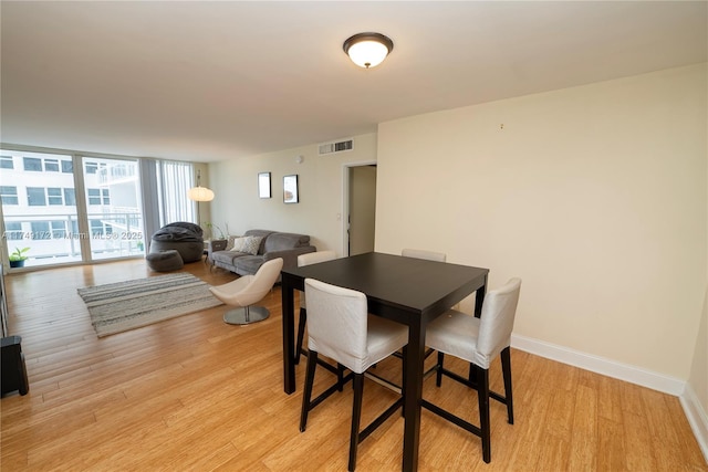 2030 S Ocean Dr Unit 618, Hallandale Beach, FL 33009 - dining room with light wood-style floors, expansive windows, visible vents, and baseboards