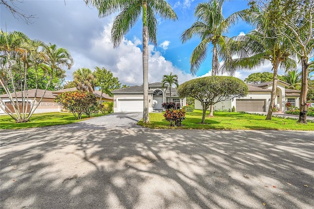 view of front of property with a front yard, driveway, and an attached garage