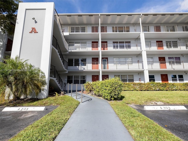 view of building exterior featuring uncovered parking