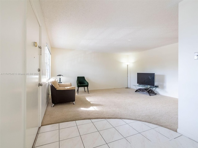 interior space featuring a textured ceiling and light colored carpet