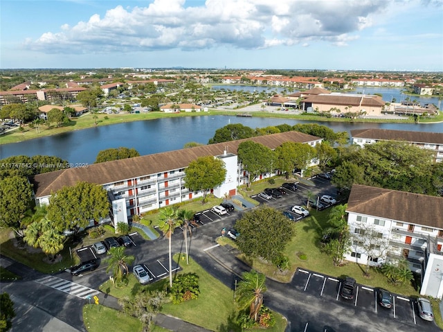 birds eye view of property with a water view and a residential view