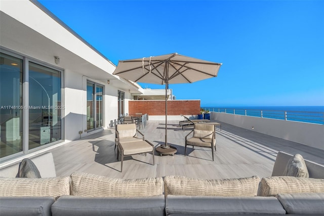 view of patio / terrace with a water view and a balcony