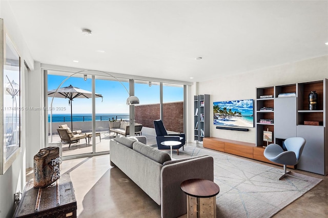 living room with finished concrete floors and a wall of windows