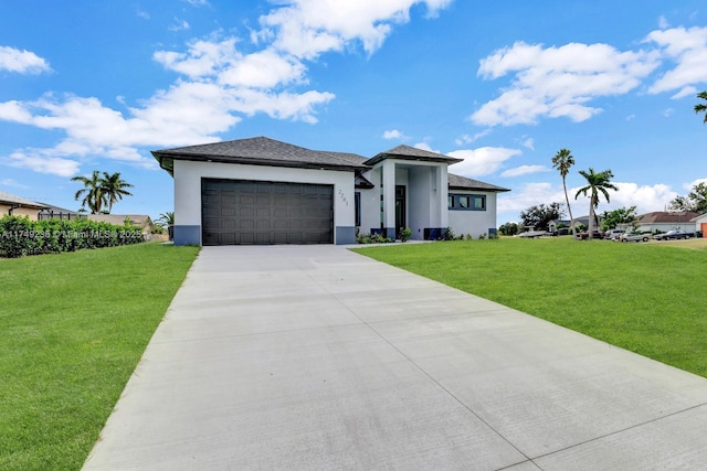 prairie-style house with concrete driveway, an attached garage, a front lawn, and stucco siding