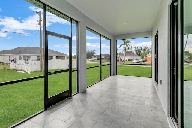 unfurnished sunroom featuring a residential view