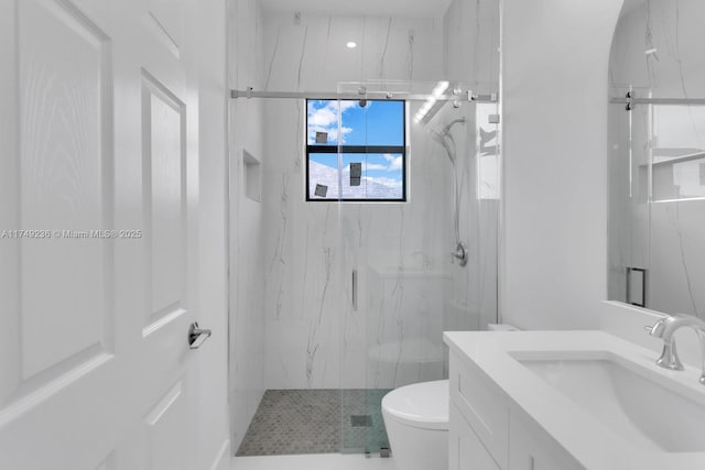 bathroom with vanity, a marble finish shower, and toilet