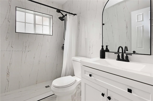 bathroom featuring toilet, vanity, tile walls, marble finish floor, and a marble finish shower