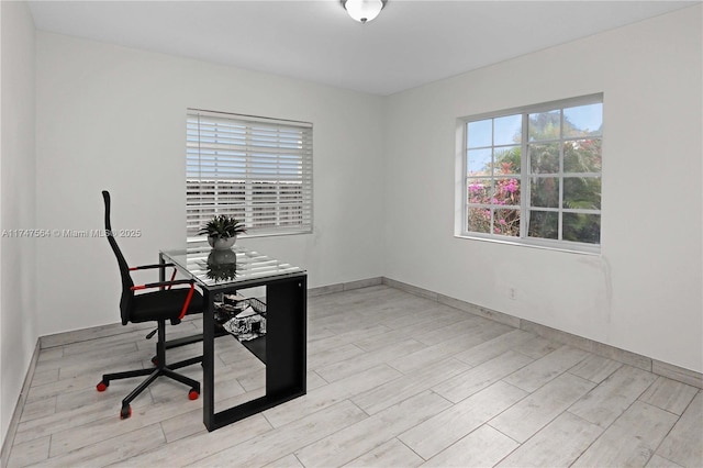 office space featuring light wood-type flooring and baseboards