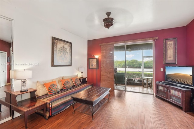 living room featuring wood finished floors and a ceiling fan