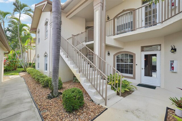 242 Newport Unit 502, Naples, FL 34114 - doorway to property with stucco siding