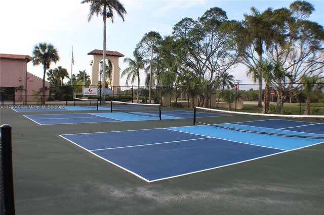 242 Newport Unit 502, Naples, FL 34114 - view of tennis court with community basketball court and fence