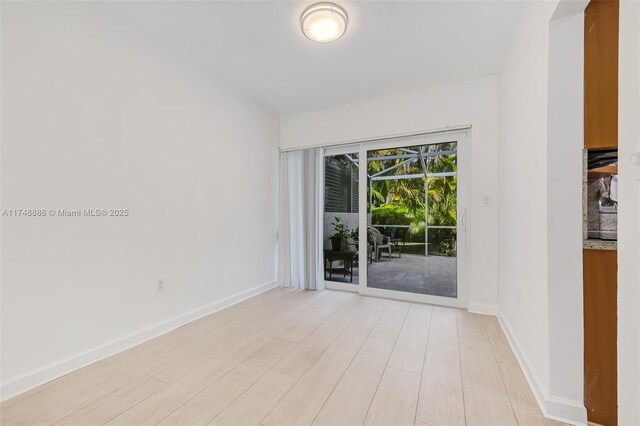 unfurnished room featuring light wood finished floors and baseboards