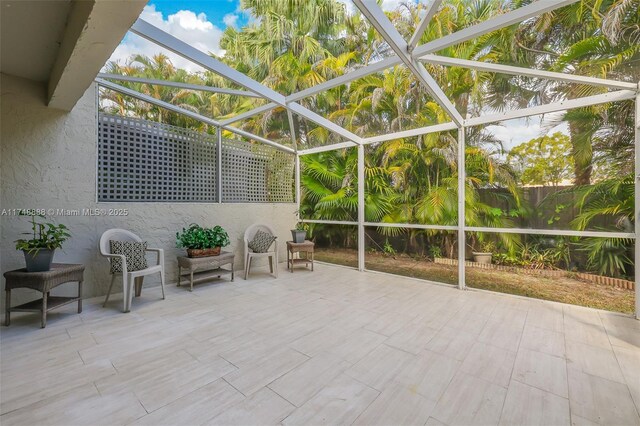 view of patio with glass enclosure