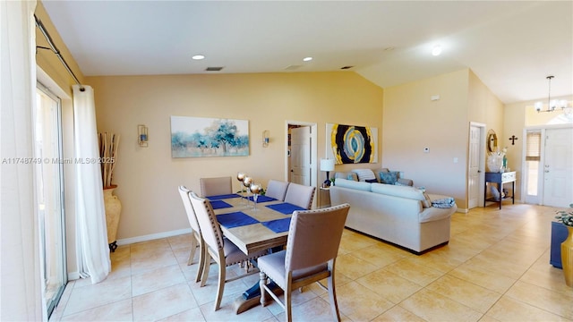 dining area with light tile patterned floors, baseboards, visible vents, lofted ceiling, and a notable chandelier