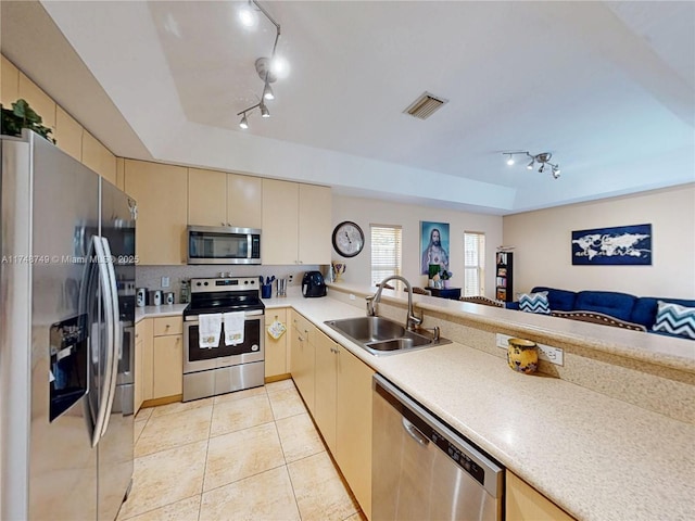 kitchen with visible vents, stainless steel appliances, a sink, and light countertops