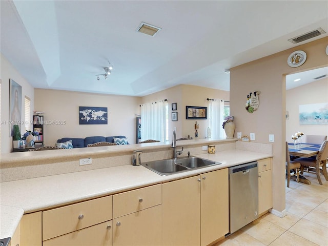 kitchen featuring a sink, visible vents, open floor plan, and dishwasher