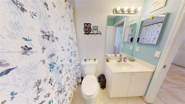 full bathroom with curtained shower, vanity, toilet, and tile patterned floors
