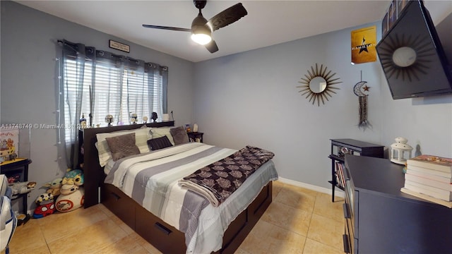 bedroom featuring light tile patterned floors, baseboards, and a ceiling fan