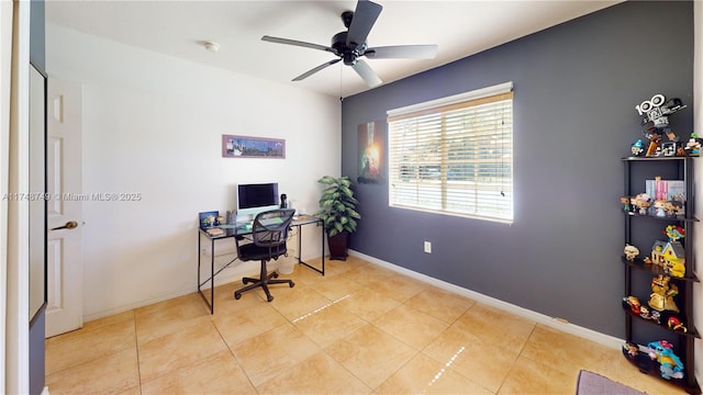 office featuring a ceiling fan, baseboards, and light tile patterned floors