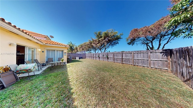 view of yard with a fenced backyard and a patio