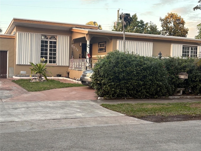 single story home featuring stucco siding