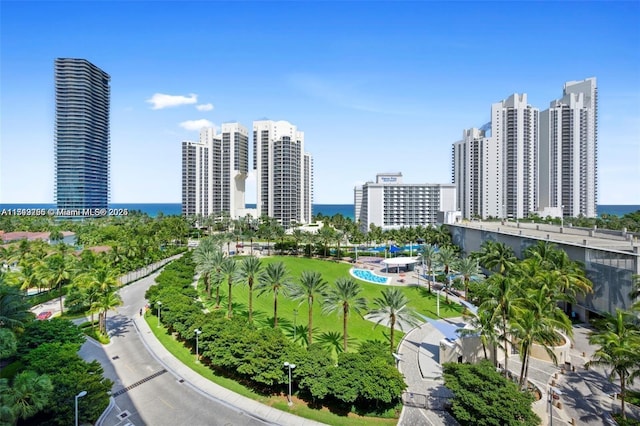 birds eye view of property with a water view and a city view