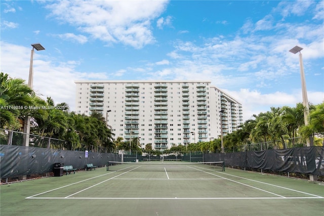 view of tennis court featuring fence