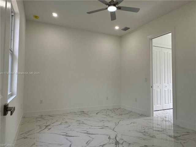 unfurnished room with marble finish floor, baseboards, visible vents, and recessed lighting