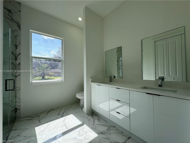 bathroom with marble finish floor, a marble finish shower, double vanity, toilet, and a sink