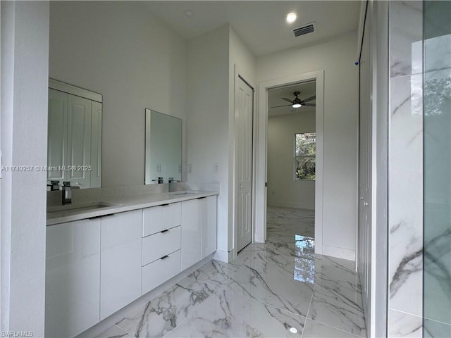 bathroom featuring a sink, marble finish floor, visible vents, and a closet