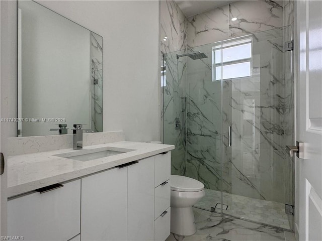 full bath featuring marble finish floor, toilet, vanity, and a marble finish shower