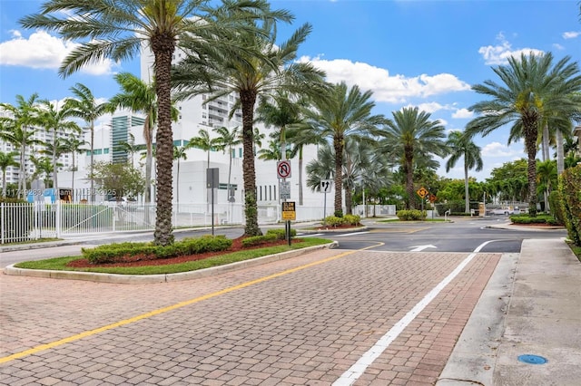 view of road featuring traffic signs, curbs, and sidewalks