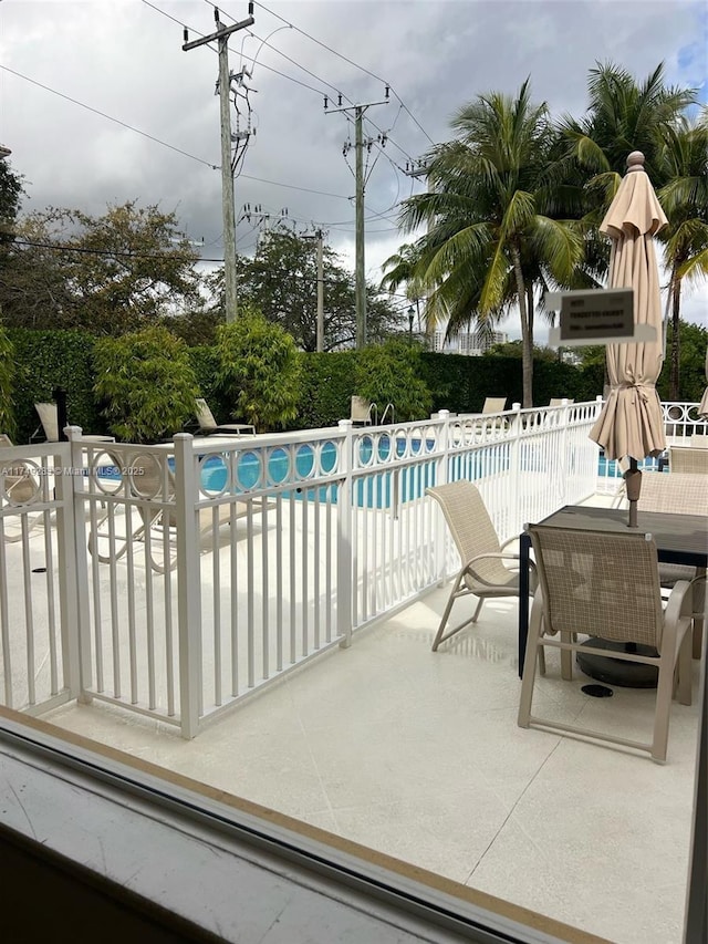 view of swimming pool featuring a fenced in pool, a patio, and fence