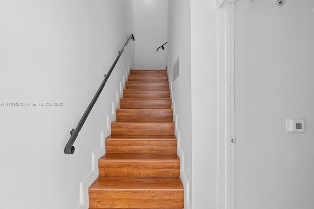 stairway with wood finished floors