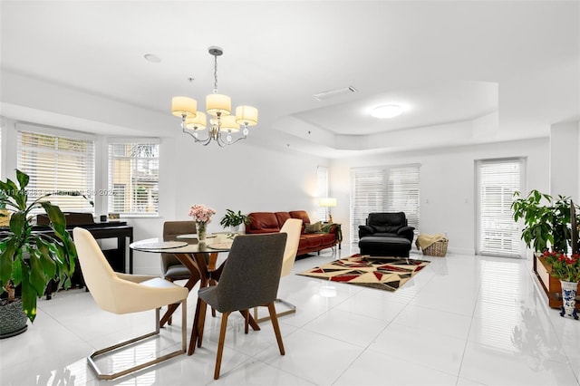 18408 NE 27th Ct Unit 18408, Aventura, FL 33160 - dining room with a tray ceiling, a chandelier, and light tile patterned flooring
