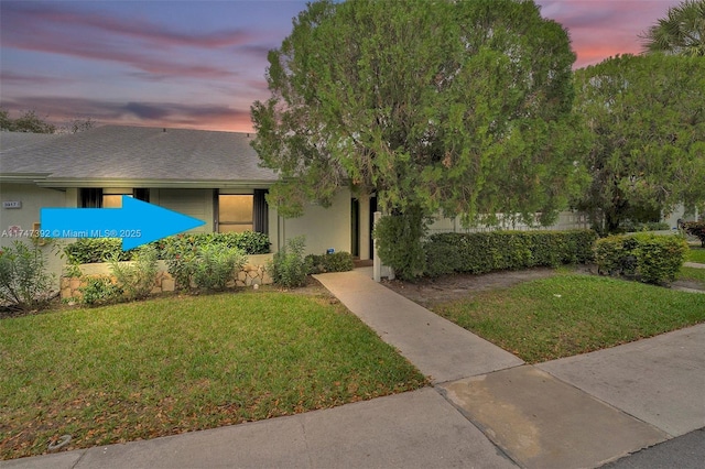 view of front of house with a front lawn and stucco siding