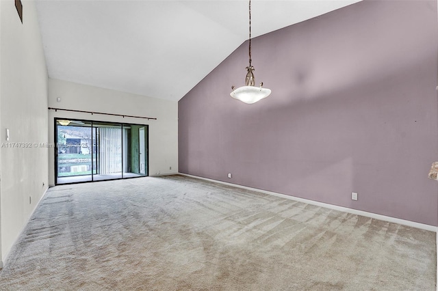 spare room with high vaulted ceiling, carpet flooring, and baseboards