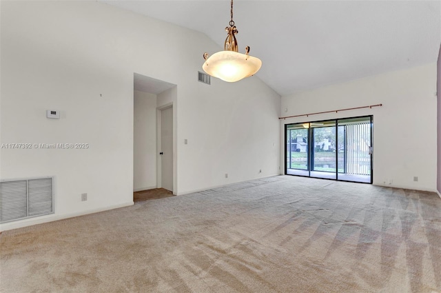 carpeted empty room with high vaulted ceiling and visible vents