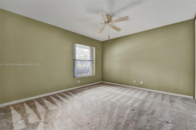 spare room featuring ceiling fan, a textured ceiling, carpet flooring, and baseboards