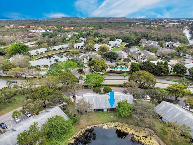 drone / aerial view featuring a residential view and a water view